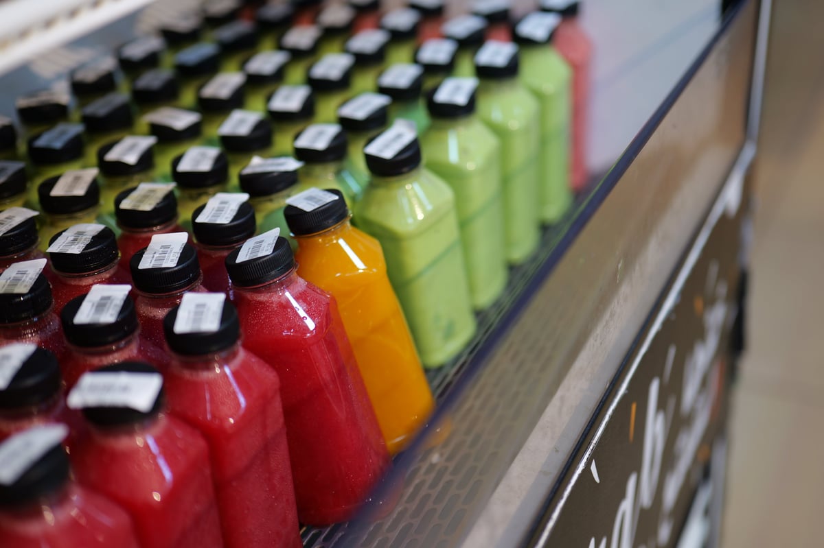 Rows of bottled fresh juices on ice